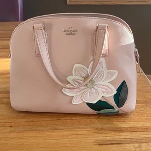 Kate Spade pink purse with a flower on the front